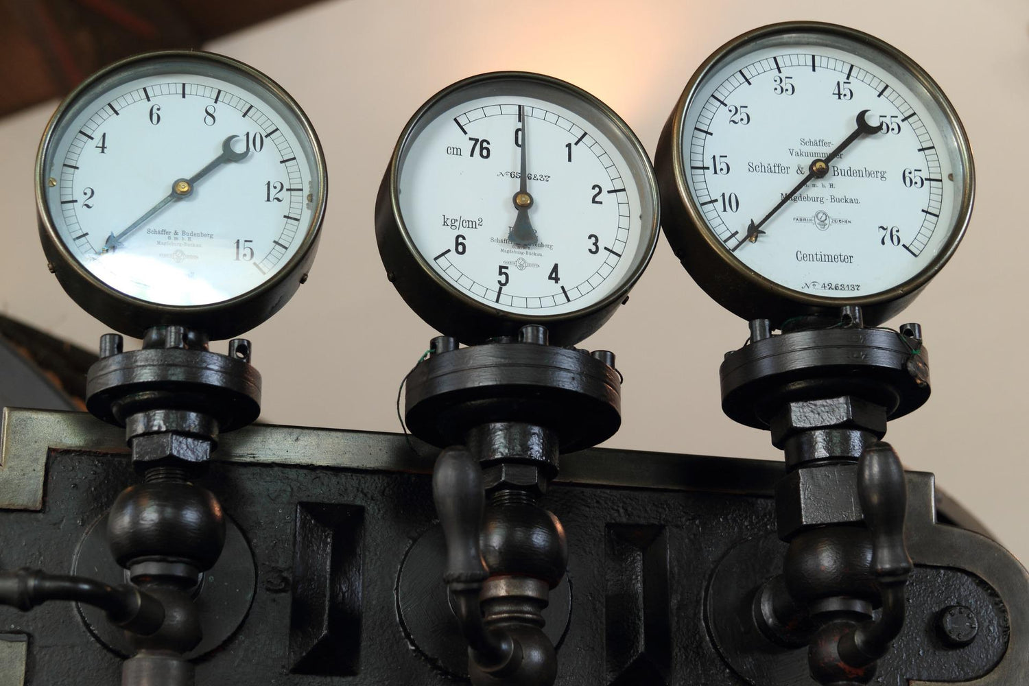 black painted diaphragm pressure gauges mounted and working on machine
